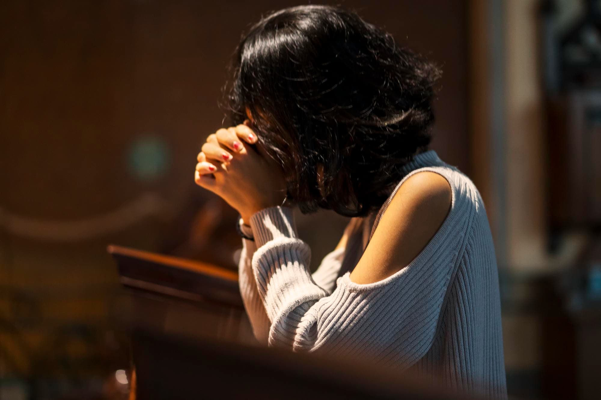 Woman praying in a church